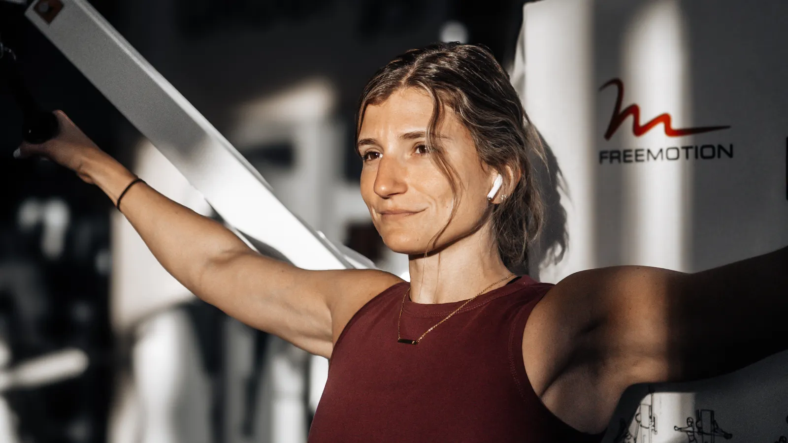 Young woman exercising on a gym machine